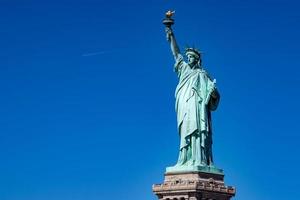 Statue of liberty in New York isolated on blue photo