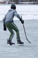 people playing hockey on frozen lake photo