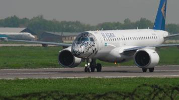 ALMATY, KAZAKHSTAN MAY 4, 2019 - Air Astana Embraer E 190 E2 P4 KHA in special Snow leopard livery, taxiing after landing, Almaty International Airport, Kazakhstan video