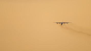 Military turboprop airfreighter on final approach before landing with sunset sky on the background. Novosibirsk video