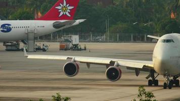 PHUKET, THAILAND NOVEMBER 28, 2016 - Rossiya Boeing 747 EI XLF taxiing before departure, Phuket airport, early morning. View from the top floor of the hotel near airport video