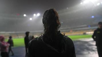 Group of athletes gathering at stadium at night video