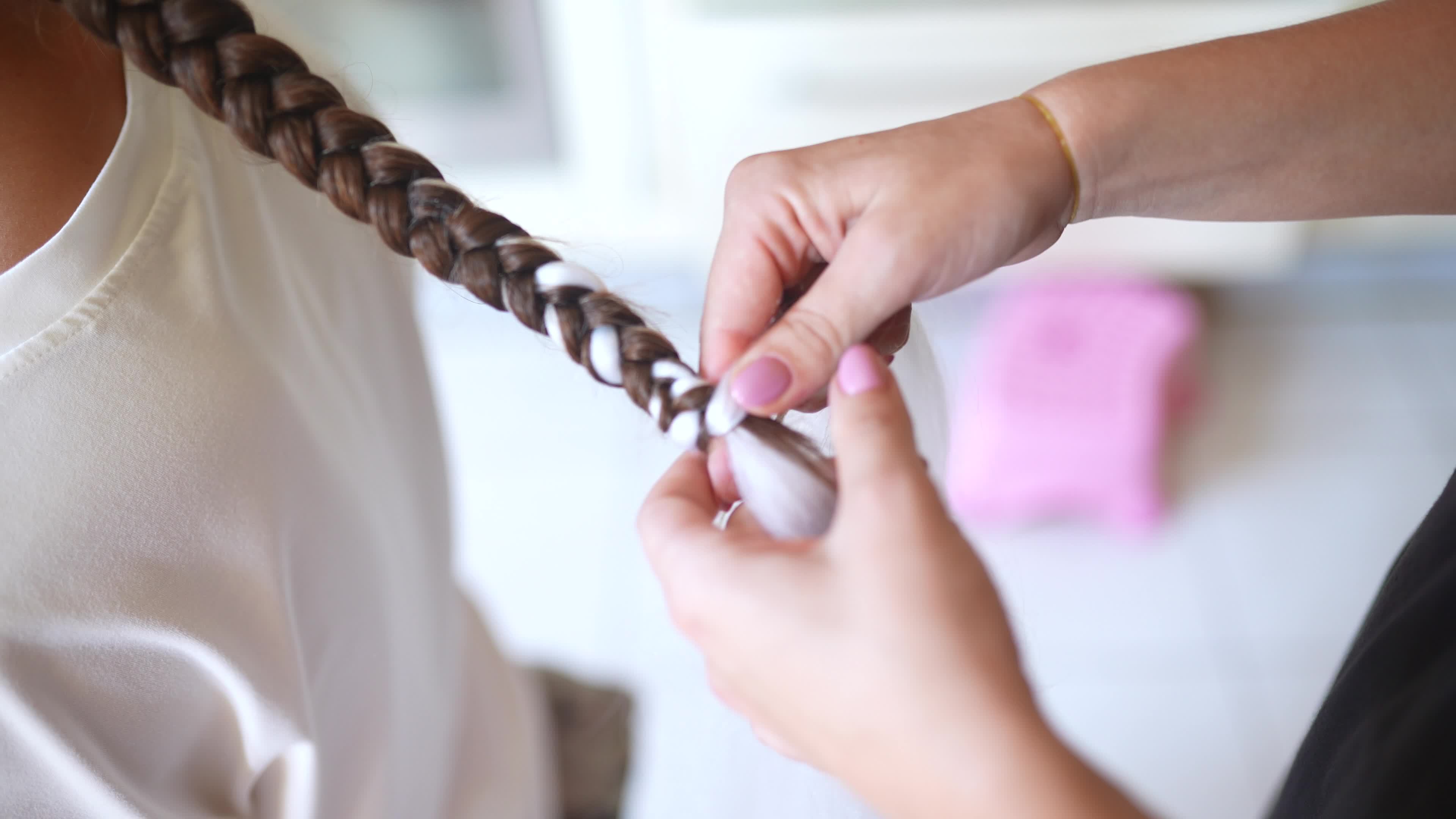 Girls braiding hair with a white strand of hair 12192296 Stock Video at