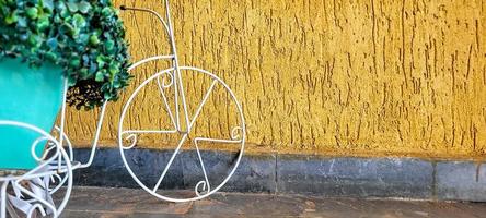 golden background with garden decoration with old bicycle photo