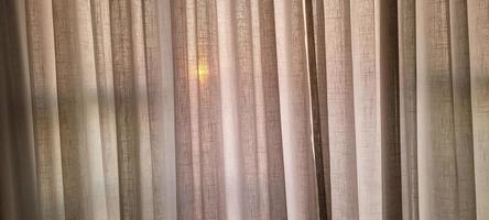 white linen curtain in apartment with sunset view in Brazil photo