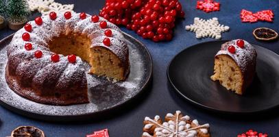 Homemade delicious round Christmas pie with red berries on a ceramic plate photo