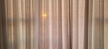 white linen curtain in apartment with sunset view in Brazil photo