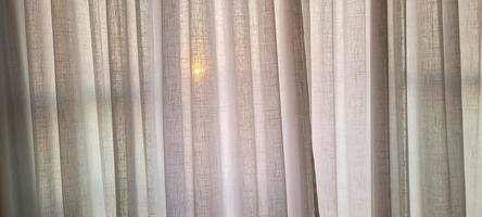 white linen curtain in apartment with sunset view in Brazil photo