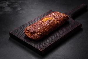 Delicious fresh ground beef meat roll with cheese, tomatoes and sweet peppers photo