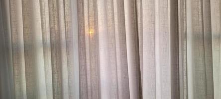 white linen curtain in apartment with sunset view in Brazil photo