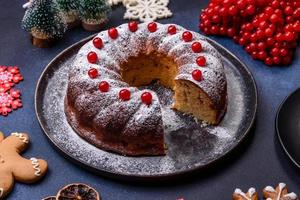 Homemade delicious round Christmas pie with red berries on a ceramic plate photo