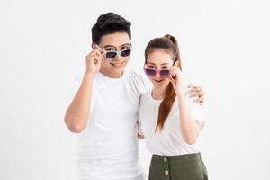 Funny couple in casual style clothes and color glasses looking at camera. photo