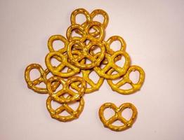 Small pretzels on a pink background. Flour product. A delicacy for tea. Wicker crispy biscuits. photo