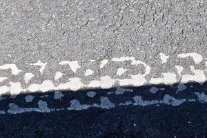 Detailed view on asphalt surfaces of different streets and roads with cracks photo