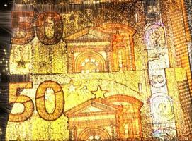 Illustration of glowing euro banknotes with a green kirlian aura around them. photo