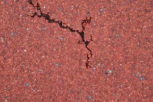 Detailed view on asphalt surfaces of different streets and roads with cracks photo