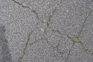 Detailed view on asphalt surfaces of different streets and roads with cracks photo