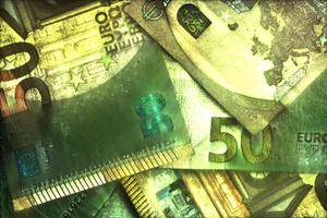 Illustration of glowing euro banknotes with a green kirlian aura around them. photo