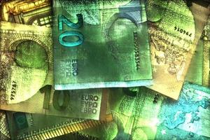 Illustration of glowing euro banknotes with a green kirlian aura around them. photo