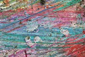 Colorful graffiti paint splashes on the wall and ground at a lost place ruin photo