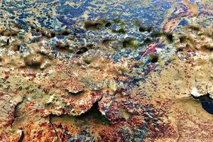 Texture of colorful graffiti paint on conrete and brick walls in red blue purple and silver photo