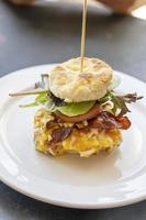 Eggs Benedict on a corn biscuit at a restaurant photo