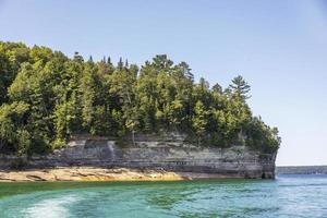 Colorful stone rocks on the edge of a lake in the summer photo