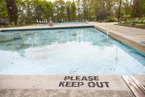 Please keep out sign on the edge of a public pool photo