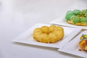 Colorful brioche style donut on a plate in a restaurant photo