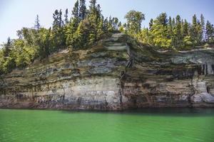 Colorful stone rocks on the edge of a lake in the summer photo