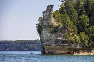 Colorful stone rocks on the edge of a lake in the summer photo