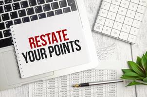 RESTATE YOUR POINTS text and notepad with pen, charts and calculator photo