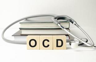 OCD Obsessive Compulsive Disorder text on wooden cube photo