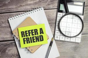 refer a friend on green sticker and office supplies photo
