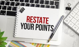 RESTATE YOUR POINTS text and notepad with pen, charts and calculator photo