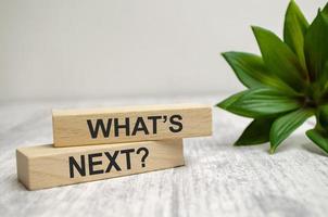 The WHAT NEXT text is written on wooden blocks and white background photo