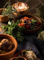 A vertical shot of a chef serving a gourmet salad dish photo