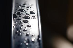 Water drops Abstract and with blurred background shines on a metal surface of a chair photo