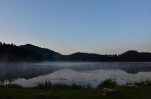 Fog Rising Off the Lake Waters in the Early Morning Hours photo