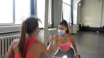 Fitness girls motivate each other in workout session video