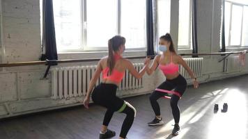 Fitness girls motivate each other in workout session video