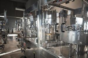 Automatic wine filling metallic machinery at wine making winery photo