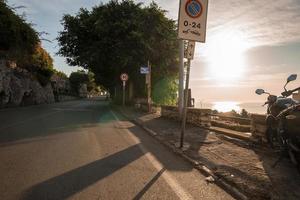 Sun shining over road at ancient coastal city during summer photo