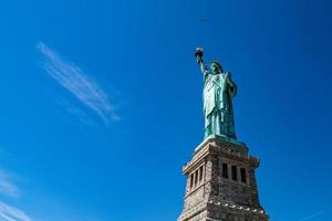 Statue of liberty in New York on blue sky photo