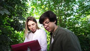 A couple of students doing a botanical research video