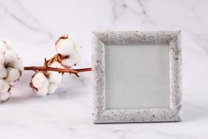 Photo frame mock up marble texture, cotton flower