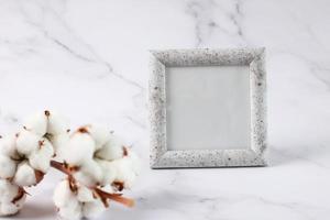 Photo frame mock up marble texture, cotton flower