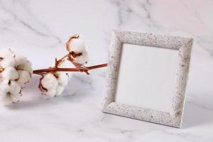 Photo frame mock up marble texture, cotton flower