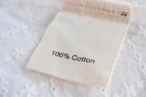 clothes label on cotton fabric texture background photo