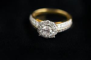 anillo de diamantes de joyería de lujo sobre fondo de tela negra foto